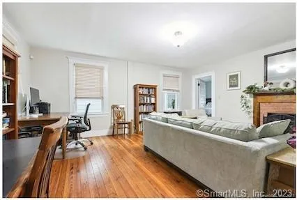 a living room with fireplace furniture and a wooden floor