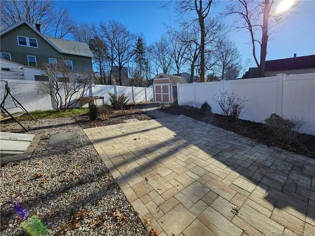a view of a yard with wooden fence