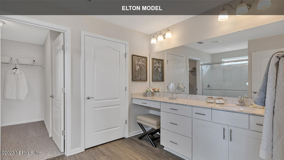 65 Zancara Street St. Augustine, FL 32084 - Photo 14 of 45 a spacious bathroom with a granite countertop sink a mirror and a