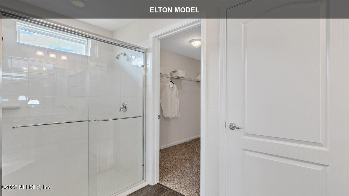 65 Zancara Street St. Augustine, FL 32084 - Photo 15 of 45 a bathroom with a glass shower door