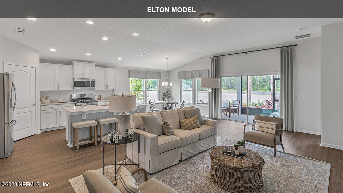 65 Zancara Street St. Augustine, FL 32084 - Photo 6 of 45 a living room with fireplace furniture and a table