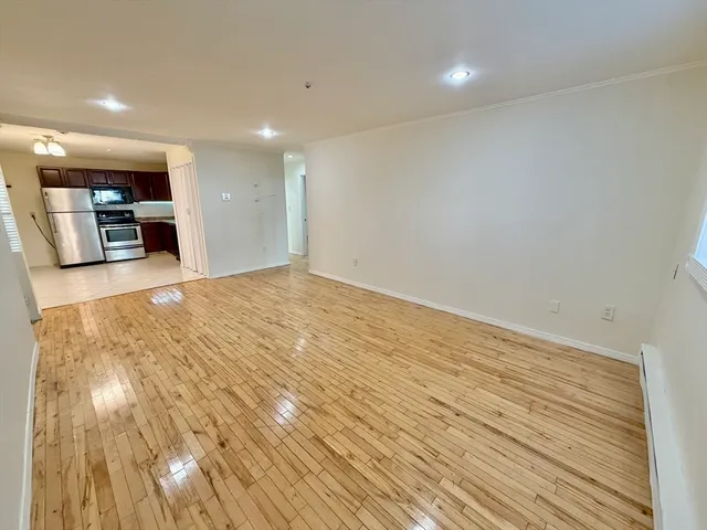 a view of a room with wooden floor