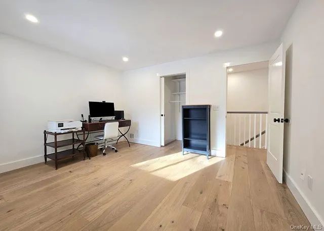 a view of a livingroom with furniture and a workspace
