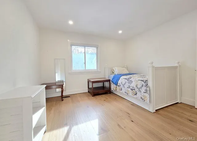 a bedroom with furniture and a window
