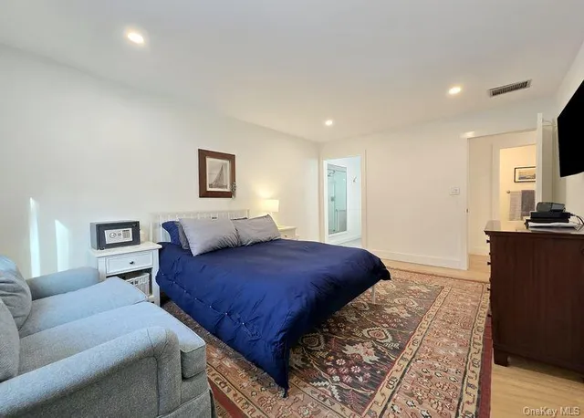 a bedroom with a large bed and a couch