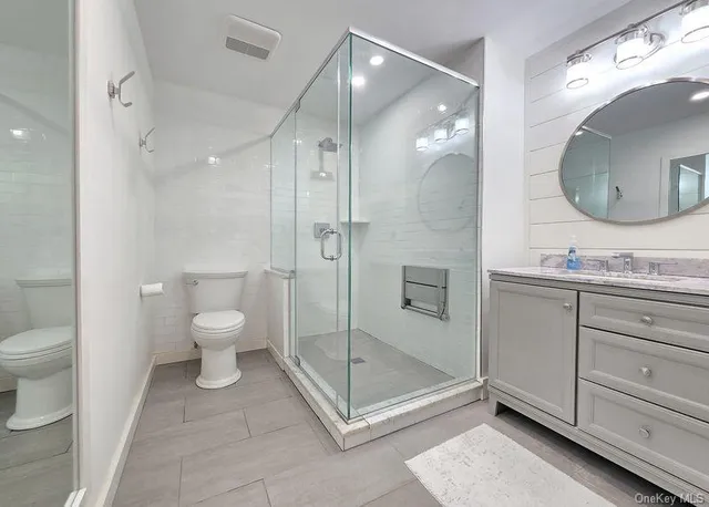 a bathroom with a toilet sink and shower