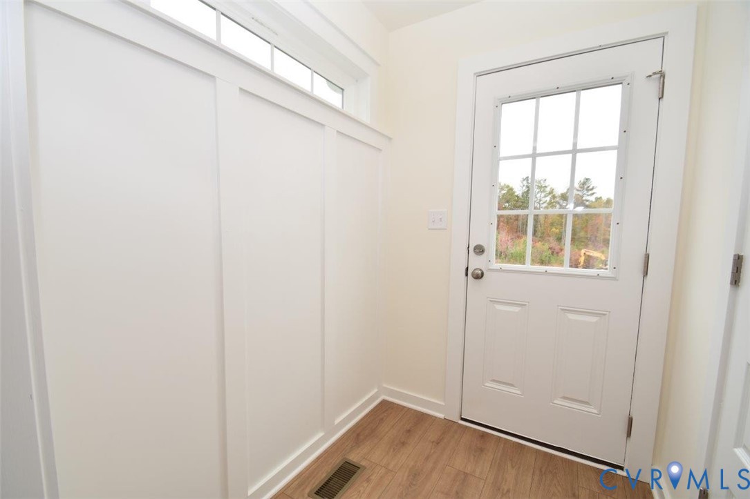 2633 Butterbean Court Henrico, VA 23231 - Photo 13 of 18 a view of an empty room with wooden floor and a window