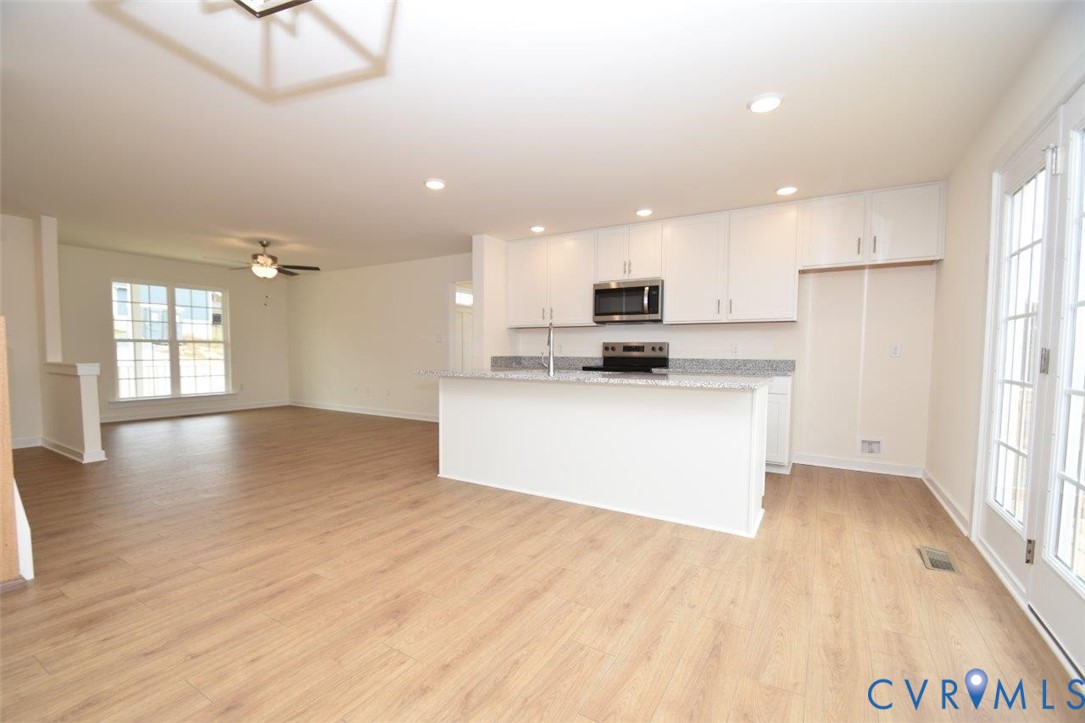 2633 Butterbean Court Henrico, VA 23231 - Photo 4 of 18 a large kitchen with stainless steel appliances kitchen island a large counter top and a wooden floors