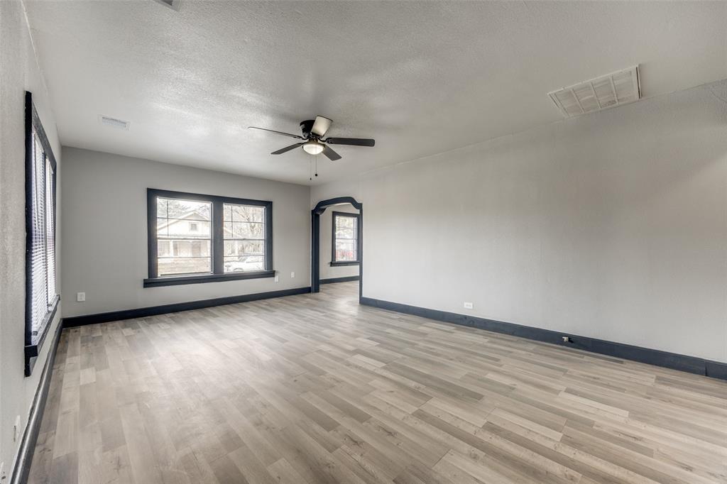 522 North Austin Avenue Denison, TX 75021 - Photo 5 of 25 a view of an empty room with a window and wooden floor