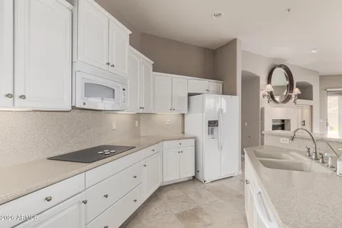 a kitchen with cabinets and white stainless steel appliances