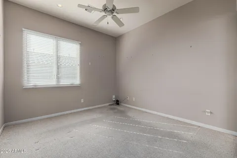 an empty room with cabinet and glass door