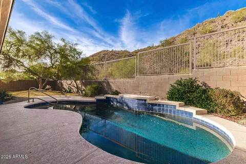 an aerial view of house with backyard space and balcony