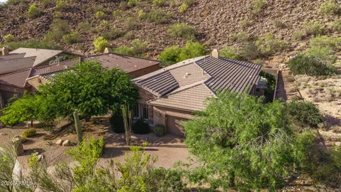 an aerial view of residential houses with outdoor space and trees