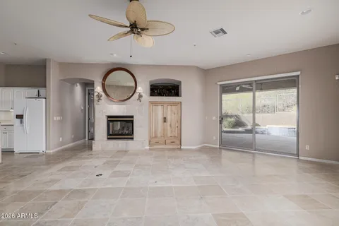 a view of an empty room with a fireplace and a window