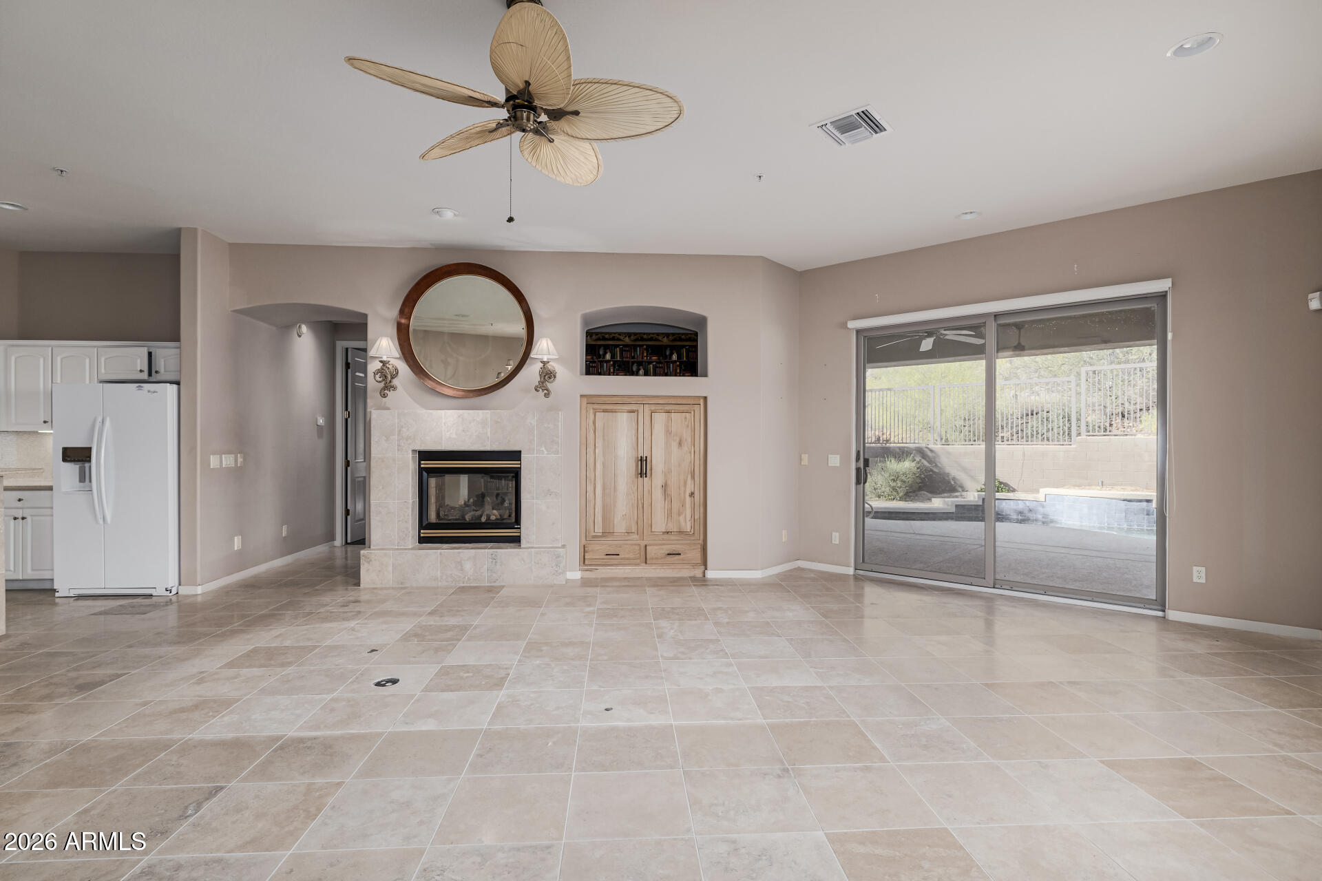 14146 East Coyote Road Scottsdale, AZ 85259 - Photo 8 of 40 a view of an empty room with a fireplace and a window