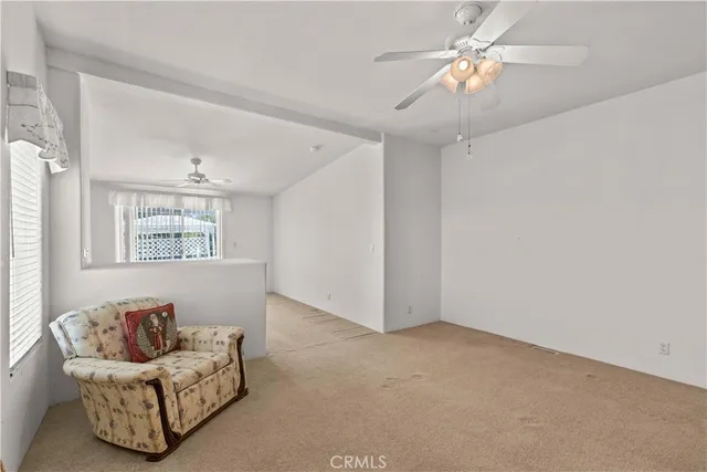 a living room with furniture and a ceiling fan