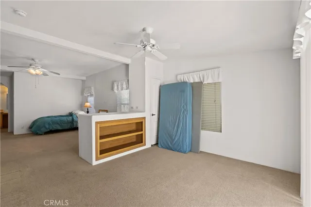 a view of a livingroom with furniture and chandelier fan