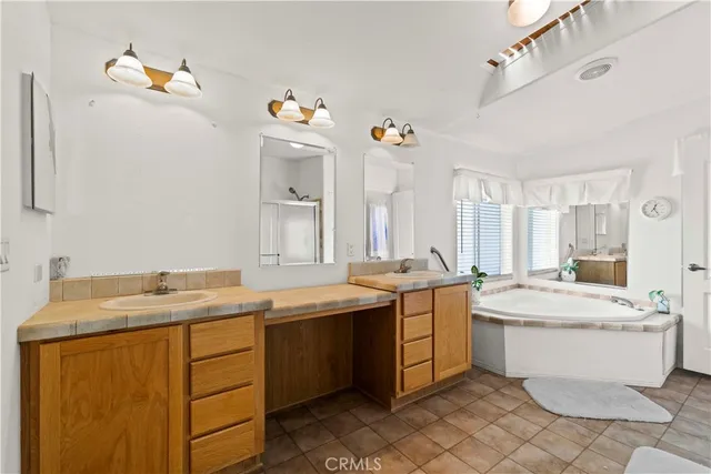 a room with a sink stove and mirror
