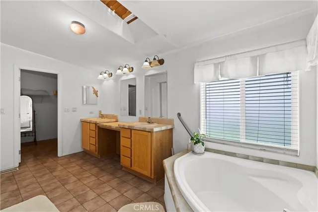 a bathroom with a tub sink and mirror