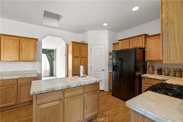 a kitchen with stainless steel appliances a refrigerator sink and stove