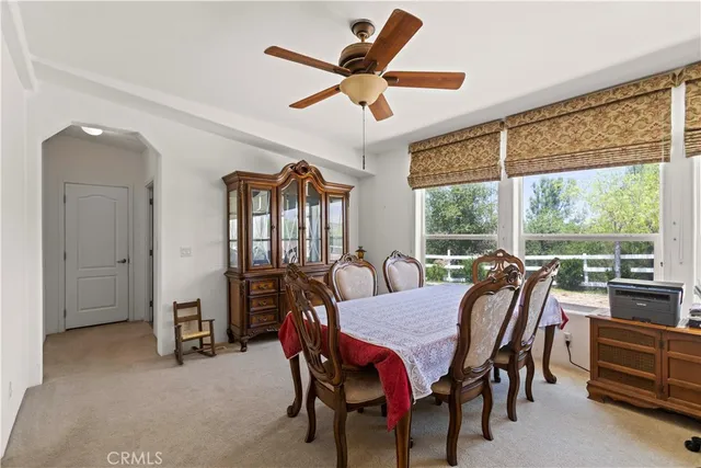 a dining room with furniture a chandelier and a rug