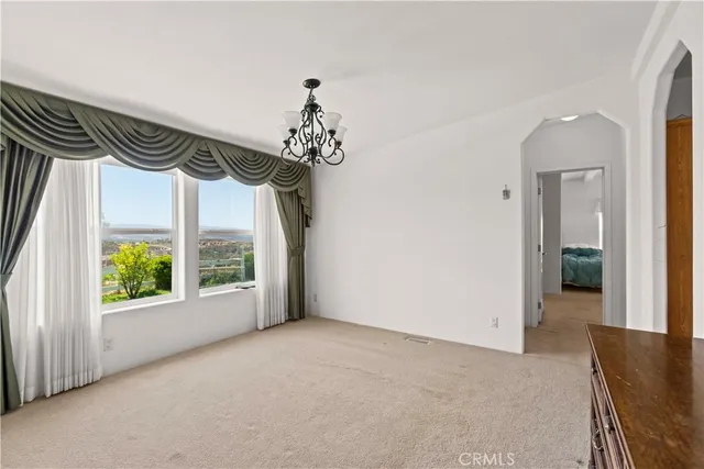 a view of a room with a window and chandelier
