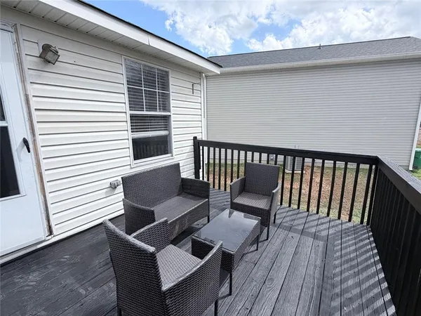 a view of a wooden chairs on the deck