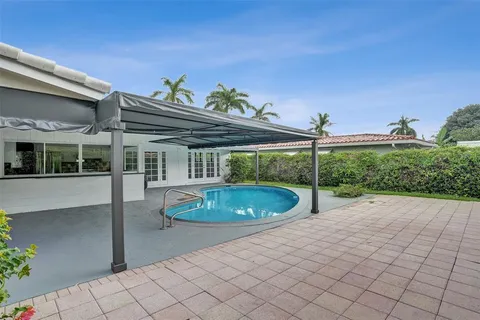 a view of a patio with a table and chairs
