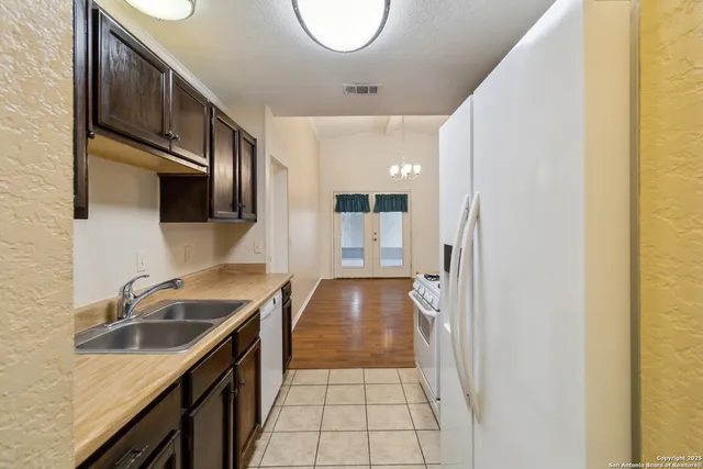 a kitchen with a sink and a refrigerator