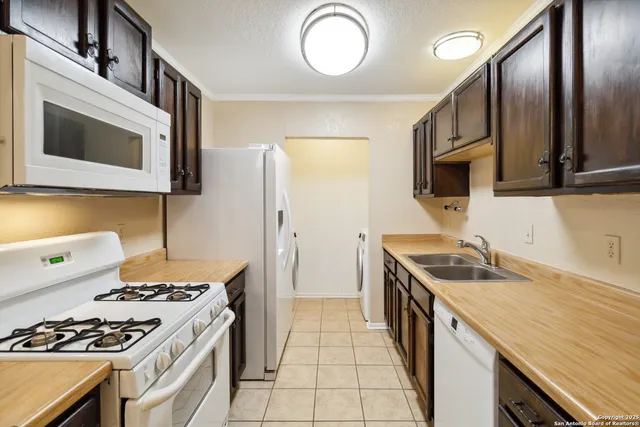 a kitchen with stainless steel appliances granite countertop a stove and a microwave