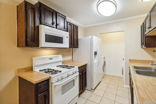 a kitchen with stainless steel appliances a stove a microwave and a refrigerator