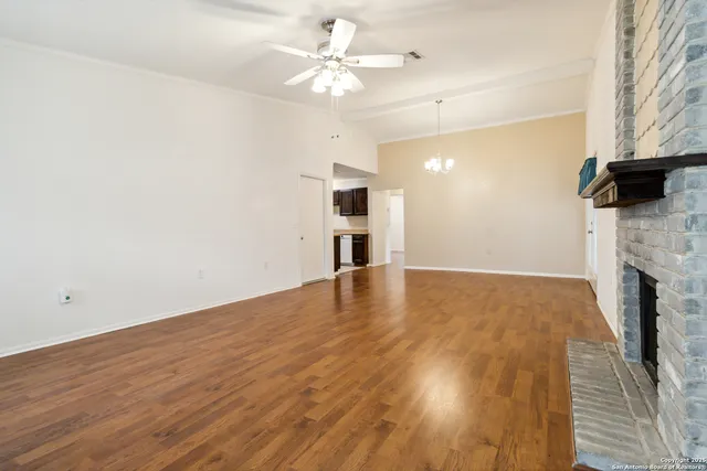wooden floor in an empty room with a fireplace