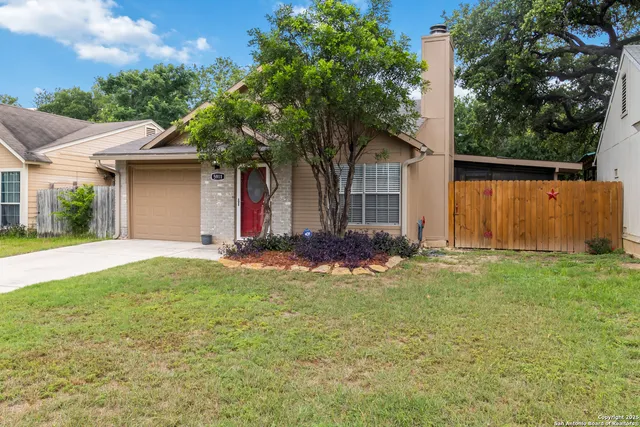 a front view of house with yard and trees