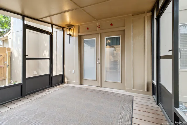 a view of empty room with large windows