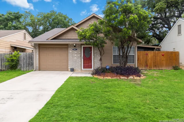 a front view of house with a garden