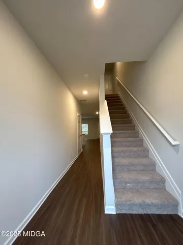 a view of entryway and hall with wooden floor