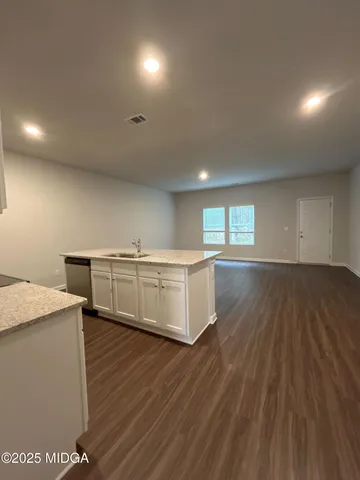 a room with a wooden floor and white walls