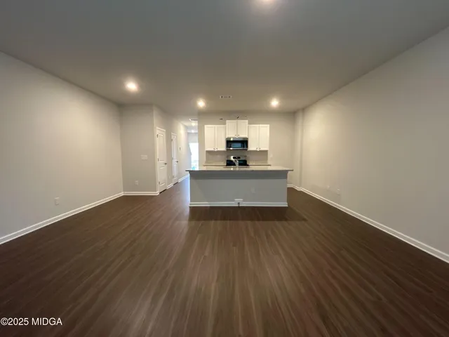 a kitchen with a sink a microwave and cabinets