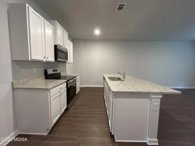 an empty room with windows and closet