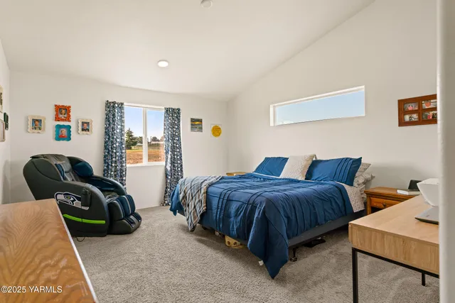 a spacious bedroom with a bed and window