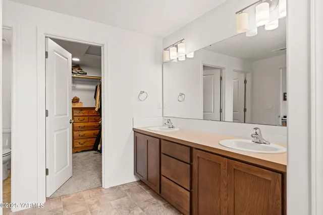 a bathroom with a sink double vanity and a mirror