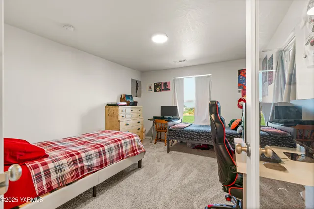 a bedroom with a bed and a desk