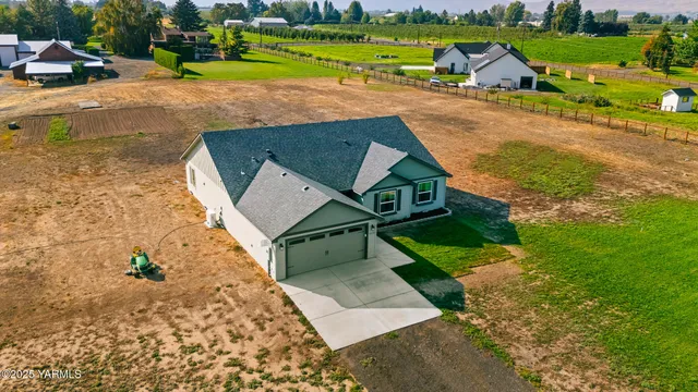 an aerial view of a house with a yard basket ball court and outdoor seating