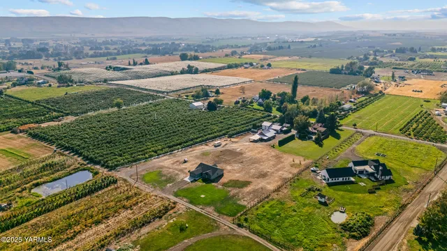 an aerial view of a residential houses with outdoor space and seating