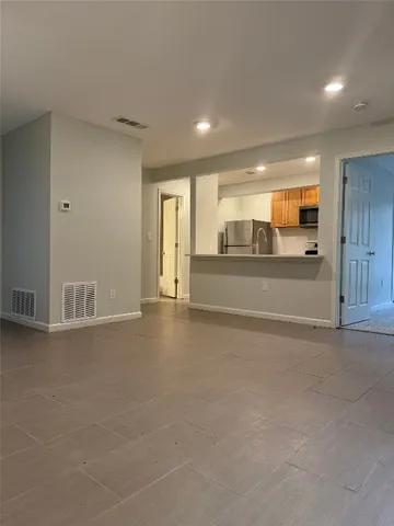 a view of a kitchen with a sink and cabinets