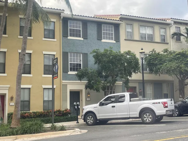 a view of a white car parked in front of a building