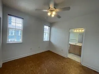 an empty room with closet and windows