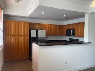 a kitchen with stainless steel appliances a refrigerator and microwave