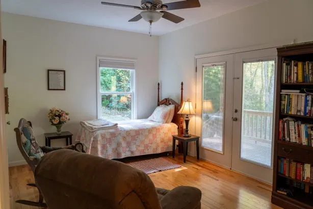 a view of a room with wooden floor and windows