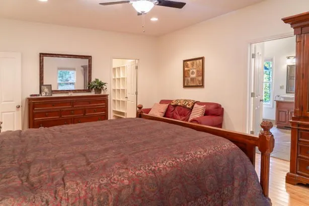 a bathroom with a granite countertop toilet a sink and a mirror